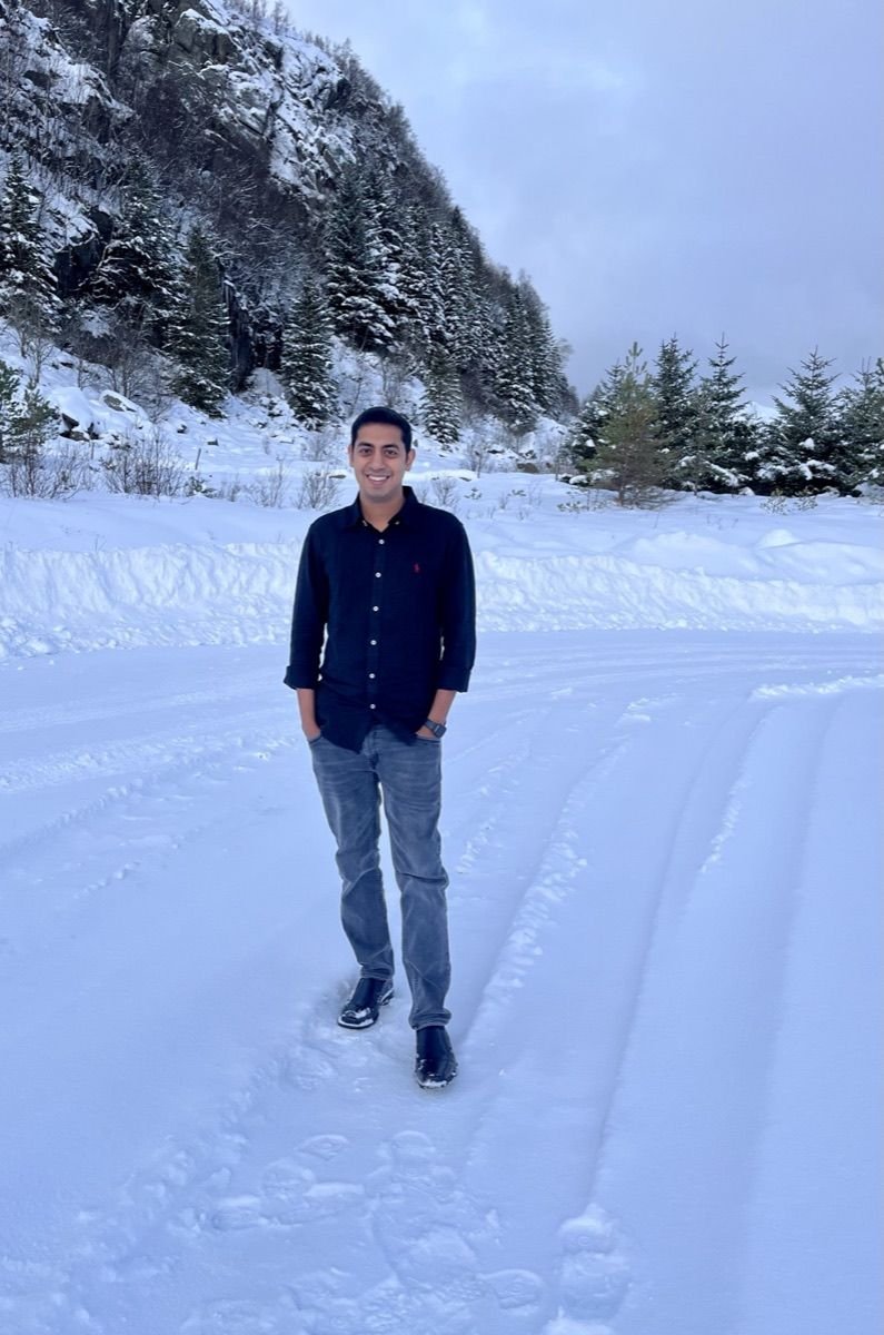 Nishanth Reddy, shrimp farmer and aquaculture consultant, smiling on a snowy mountain road