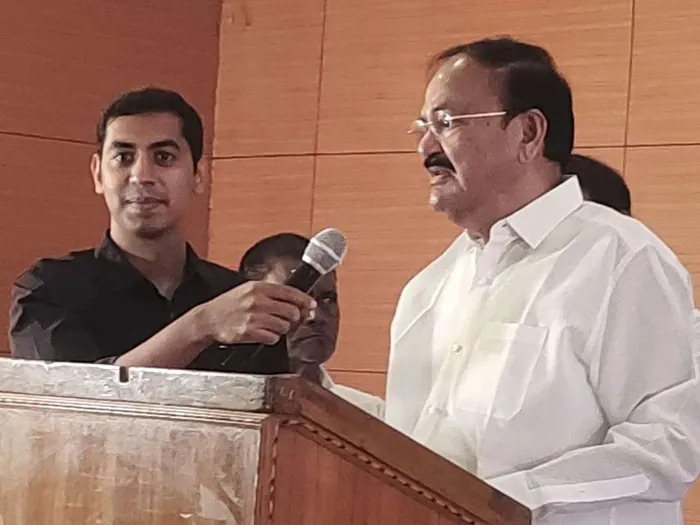 Nishanth Reddy holding the microphone for Vice President M. Venkaiah Naidu